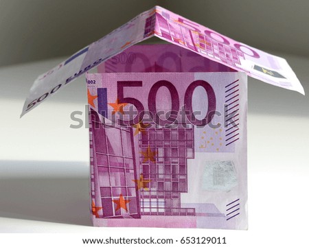 A paper house made of 500 Euro bills isolated