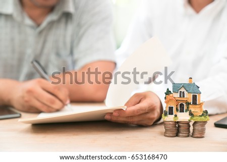 Close up of female hand reviewing real estate contract.