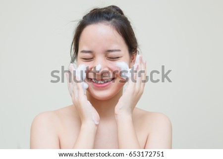 cute teenager Asian girl with baby face skin enjoy herself with bubble cleansing foam  Royalty-Free Stock Photo #653172751