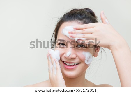 cute teenager Asian girl with baby face skin enjoy herself with bubble cleansing foam  Royalty-Free Stock Photo #653172811