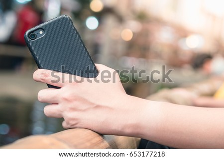 Smartphone case :  held by a woman's hand