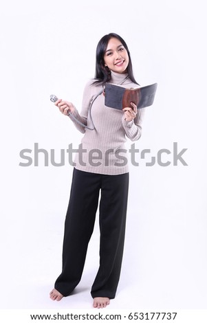 Charming beautiful tan skin Asian woman doctor hand holds stethoscope. Presenting your product. An enthusiastic intern looking at camera with confidence and hand hold tablet. Healthcare isolated.