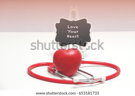 LOVE YOUR HEART word with Stethoscope and Heart shape on white background. 
