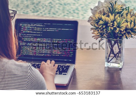 Programmer Typing New Lines of HTML Code. Laptop and Hand Closeup. Working Time. Web Design Business and Web Development Concept. Relaxing Environment. Freelance Work. Programming for all Genders. Royalty-Free Stock Photo #653183137