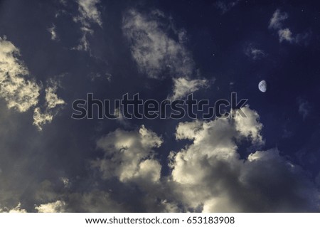 yellow sunset with moon and clouds like day and night