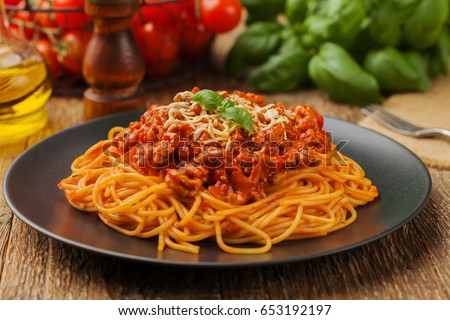 Delicious spaghetti served on a black plate Royalty-Free Stock Photo #653192197