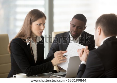 Angry dissatisfied businesswoman holding contract arguing with contractor, pointing at terms failed to perform, demanding termination, loss compensation, defrauded cheated investor protecting rights  Royalty-Free Stock Photo #653199844