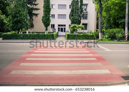 Red crosswalk taking to a public residential building