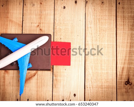 White plane on passport with ticket flight travel and map on wooden table background. Travel concept background, free copy space. Flat lay.