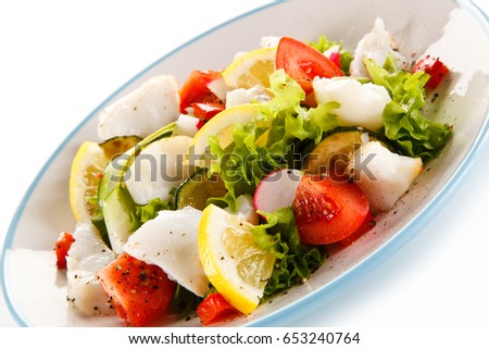 Salad with grilled fish fillet on white background 