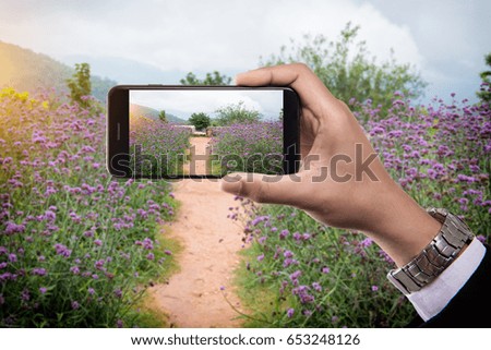 Man holding mobile smart phone taking pictures