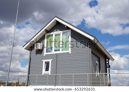 Prefabricated house of gray color from a natural tree Royalty-Free Stock Photo #653292631