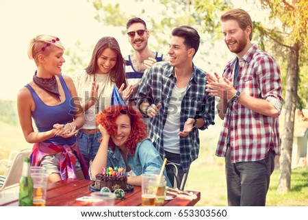 Girl celebrates birthday in nature with her friends
