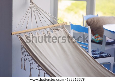 Cozy interior with hammock near the big  window, bright sunny day, blue floor.