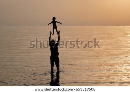 Father and son playing in the sea