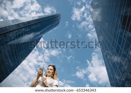 Woman with phone in the city