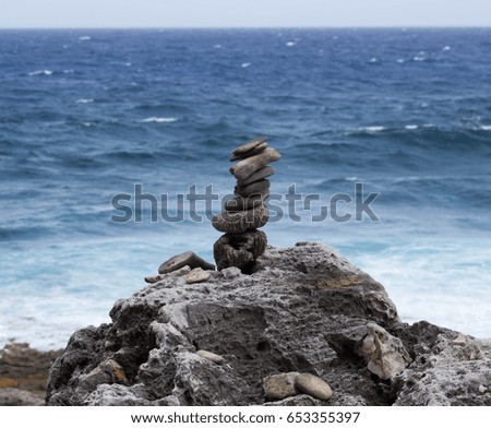 Balanced rocks stacked in front of the Caribbean Sea.