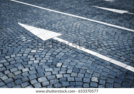 abstract background or texture White arrows on a stone path