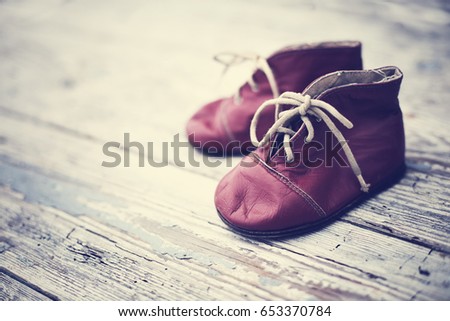 Baby shoes on wooden background. Stylish baby shoes.selective focus 