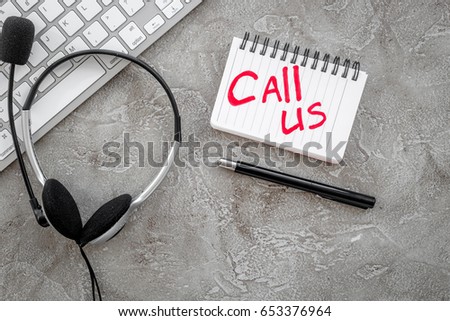 customer support service desktop with contact us copy stone background top view