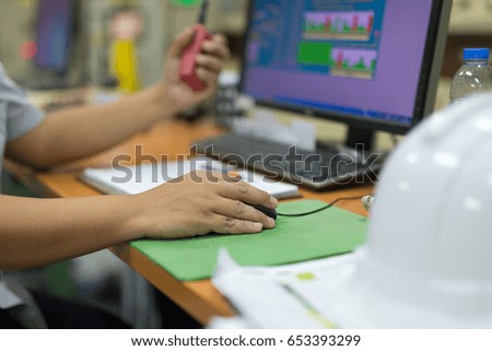 Mouse in hand people are working on wooden table in control room manufacturing