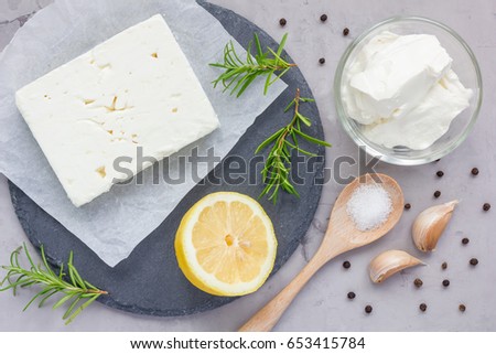 Ingredients for feta, cream cheese, rosemary, lemon and garlic dip on slate board, top view Royalty-Free Stock Photo #653415784