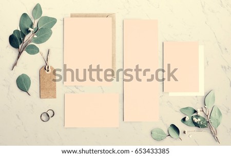 Blank Papers Laying on Marble Table With Leaves Decoration