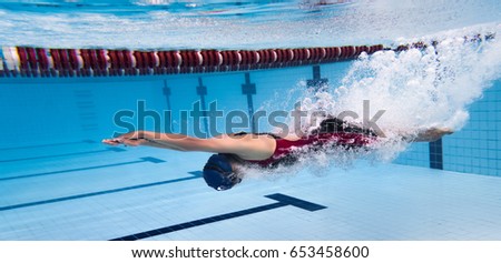swimmer jump from platform jumping a swimming pool.Underwater photo