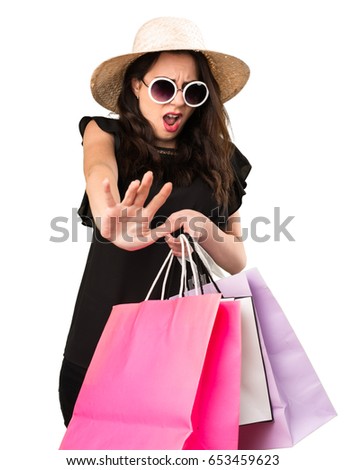 Beautiful young girl  with shopping bag making stop sign