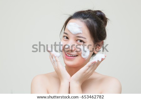 cute teenager Asian girl with baby face skin enjoy herself with bubble cleansing foam  Royalty-Free Stock Photo #653462782