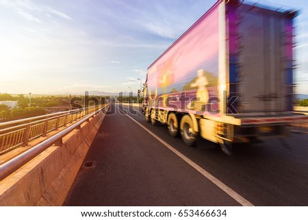 Beautiful sunset with motion blurred truck on the road