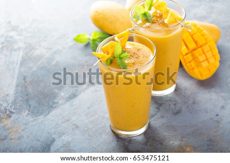 Refreshing and healthy mango smoothie in tall glasses