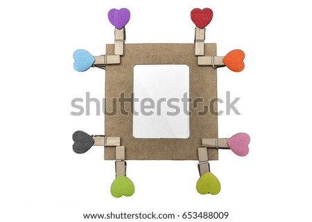 Image of eight wooden heart clips with blank of cardboard frame, isolated on white background