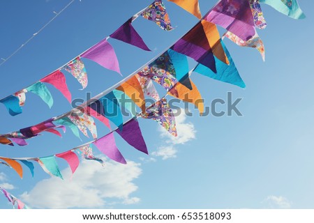 Summer festive bright colorful vintage bunting decoration and blue sky, happy joy freedom celebration , social distancing concept Royalty-Free Stock Photo #653518093