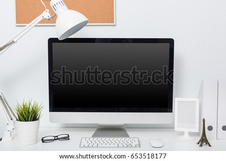 Modern home office computer monitor workspace on white desk