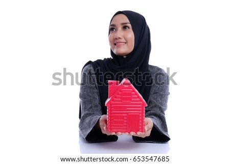 Pretty Asian woman holding home icon, daydream life conceptual with isolated white background