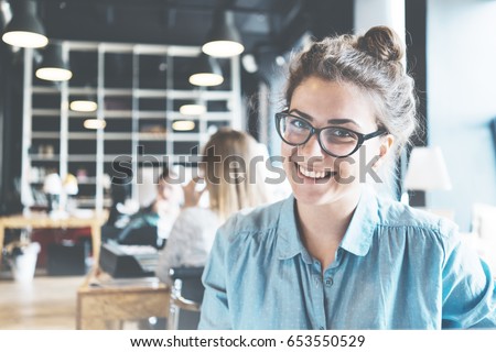 Portrait of handsome business lady working at big coworking. Ordinary workday in loft office Royalty-Free Stock Photo #653550529
