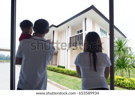 Father and Mom With baby looking at Residence for family