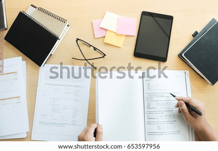 Close up of studying student hands writing in book during lecture education students college of university, Reading, Learning, technology and Exam. Education concept, top view.