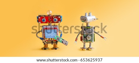Robots on yellow background. 4th industrial revolution automation concept. Computer service maintenance, repair fix. IT cyber specialist, smiley red head, usb flash stick, quote Hello. Copy space.