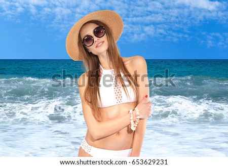 Young woman in stylish swimsuit relaxing on beach. Fashion and summer vacation