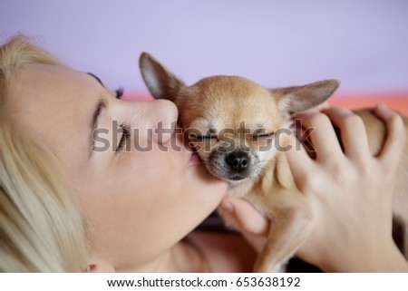 Teenage girl with her dog laying in bed