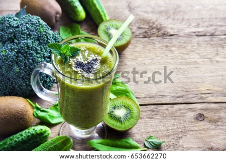 Green vegetable and herbs smoothie with heart of poppy and sesame seeds. Love healthy raw food concept.