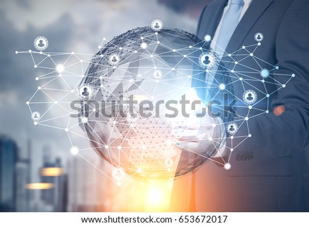 Close up of an unrecognizable businessman standing against a cityscape with a globe hologram and a network sketch on top of it. Toned image double exposure mock up.