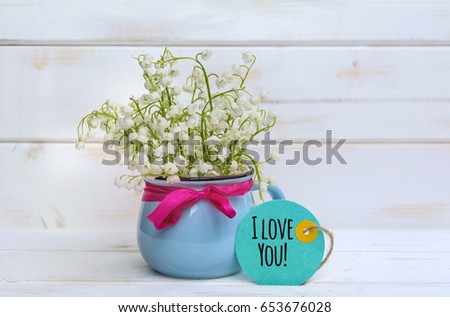 beautiful lily of the valley  flowers bouquet  with i love you message card 