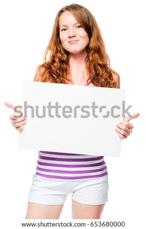 Happy young girl in a striped T-shirt with a poster in hands on a white background 