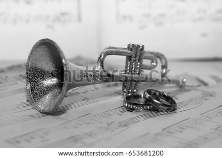  trumpet and wedding rings, old paper