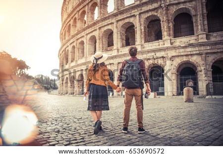 Young couple at the Colosseum, Rome - Happy tourists visiting italian famous landmarks Royalty-Free Stock Photo #653690572