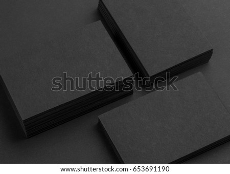 Photo of black business cards. Dark template isolated on black background. For graphic designers presentations and portfolios. Business card mock-up black on black.
