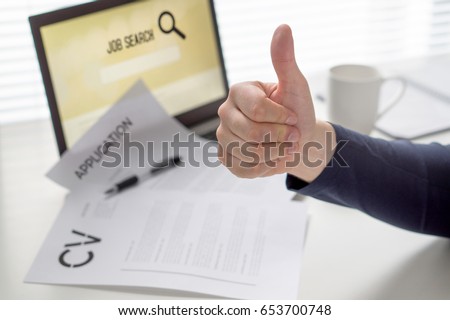 Thumbs up for job search. Applicant with positive attitude. Happy jobseeker. Cheerful man pleased with finding work. Hired or motivated job seeking person. Successful employment concept.  Royalty-Free Stock Photo #653700748